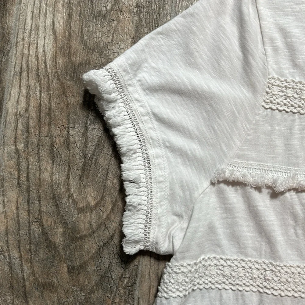 Style & Co white tee with stripes of fringe and crochet